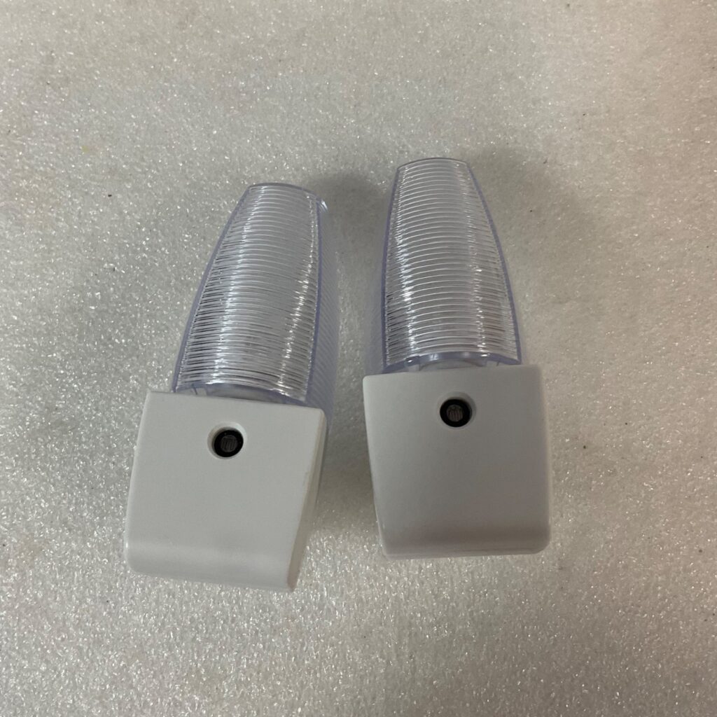 LED Plug In Night Light 4in Ribbed Clear Lens White Base 2pc - Image 1