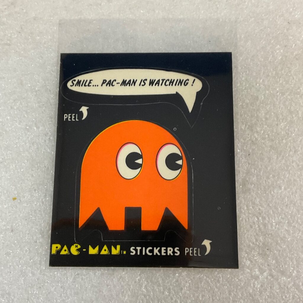 1980 Fleer Pac-Man Sticker #38 Smile Pac-Man Is Watching Orange Ghost - Image 1