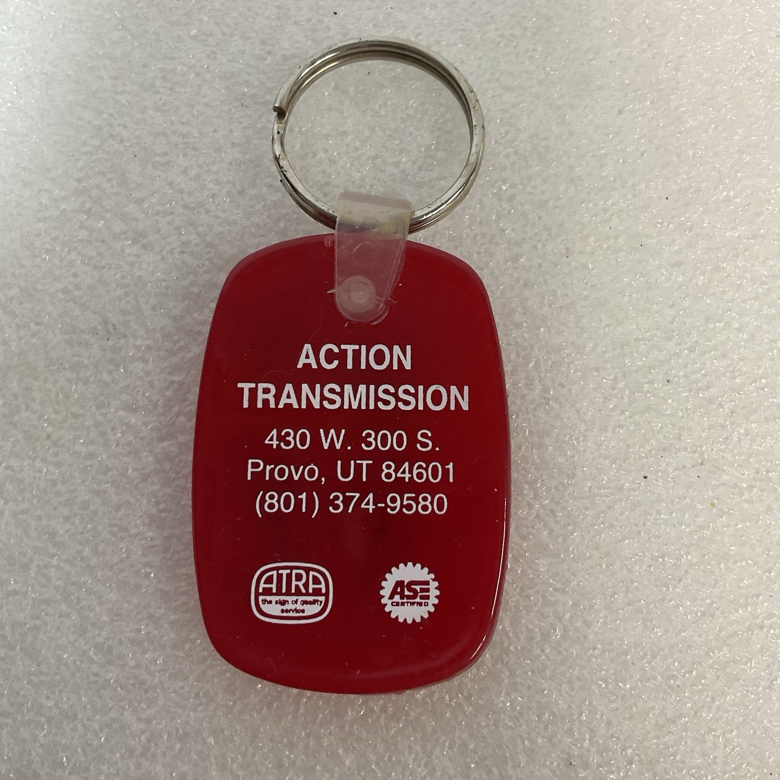 Vintage Action Transmission Provo UT Red Plastic Keychain ASE ATRA Promo Key Fob - Image 1