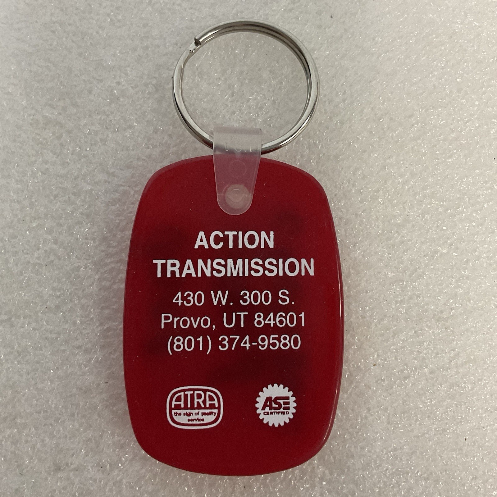 Vintage Action Transmission Provo UT Advertising Keychain Red ATRA ASE - Image 1