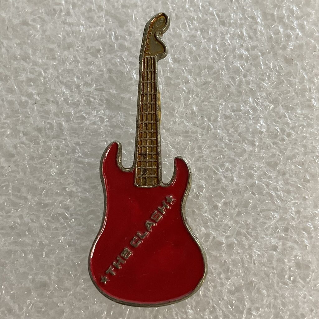 1980’s Vintage The Clash English Rock Band 1.5" Red & Gold Metal Guitar Pin - Image 1
