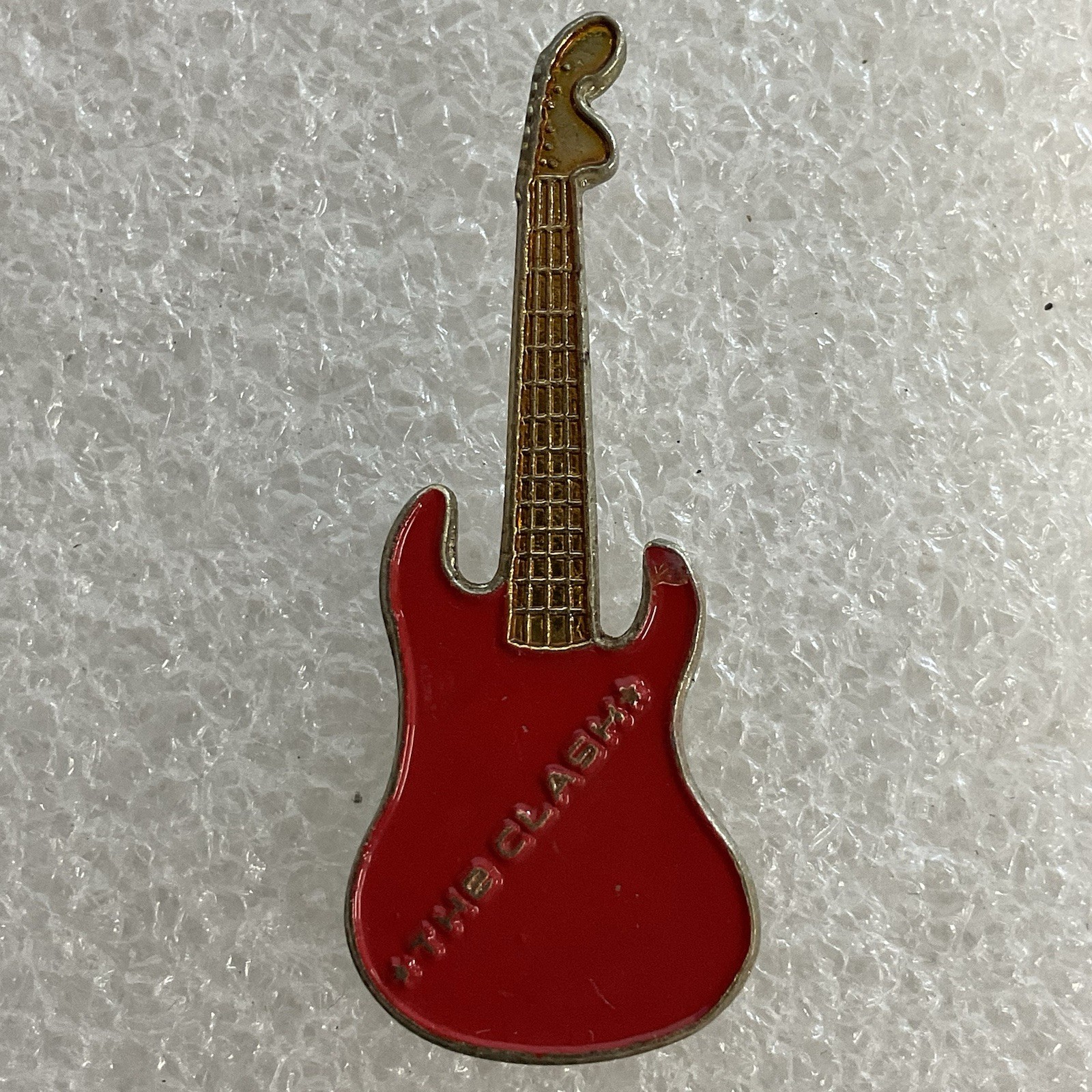 1980’s Vintage The Clash English Rock Band 1.5" Red & Gold Metal Guitar Pin - Image 1